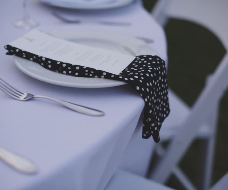Wedding place setting with a polka-dot napkin